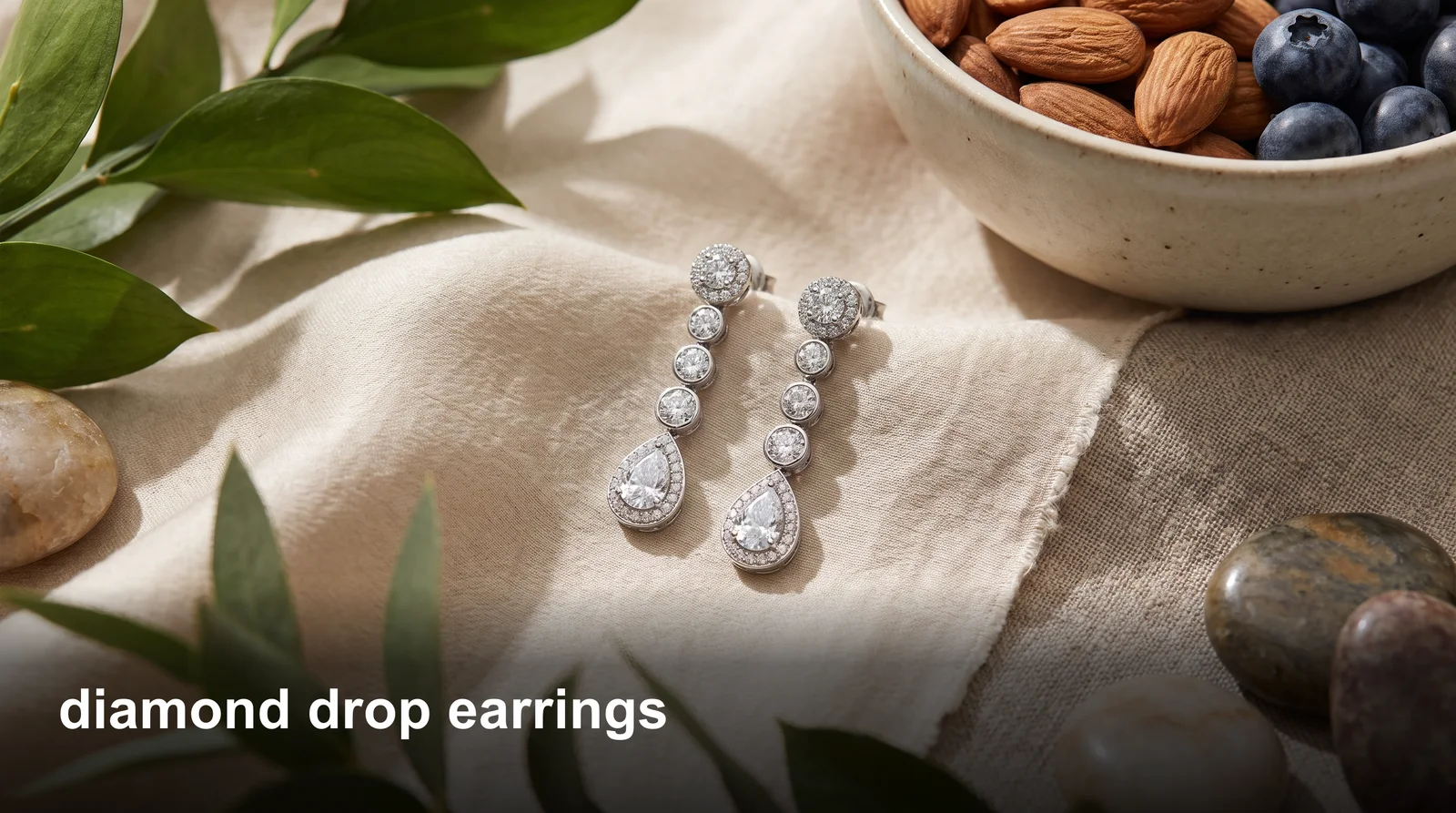Diamond drop earrings dangling from a model's ear, catching light with a sparkling teardrop-shaped design