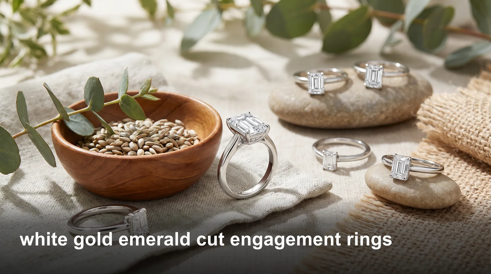 White gold emerald cut engagement ring with a clear step-cut diamond and sleek polished band
