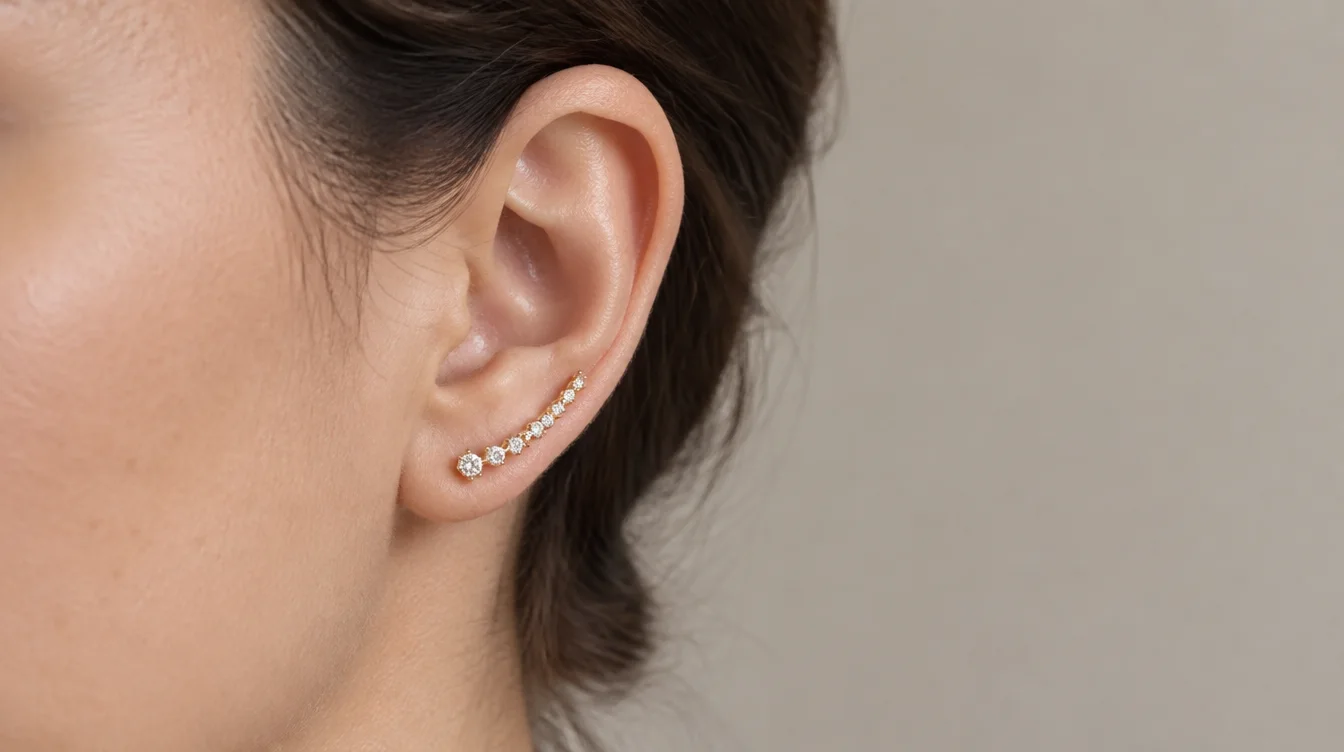 Pierced ear climber following the outer lobe, with its lower end at the piercing.